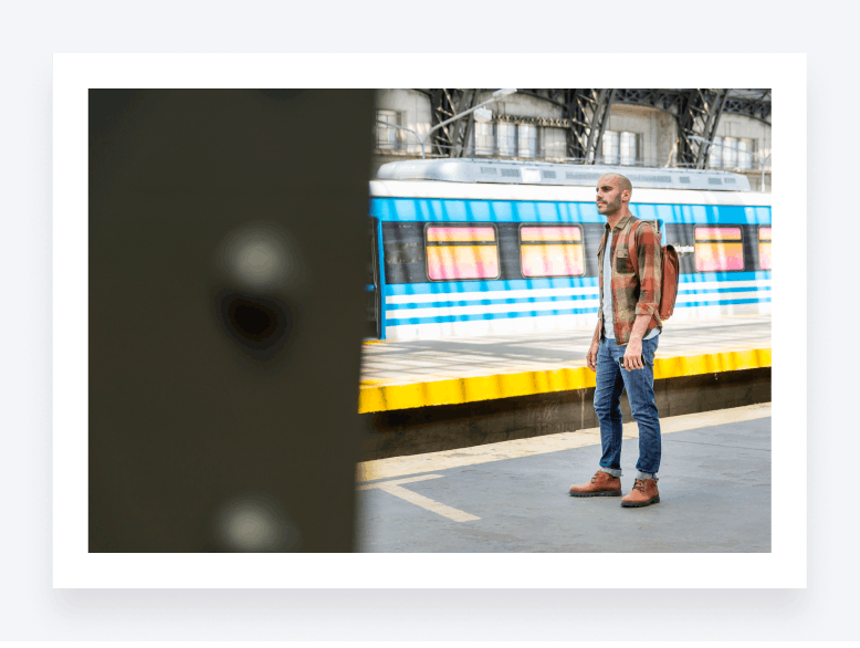 Image showcasing an accountant standing on a train platform, with a gap between the platform and the train doors